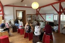 Beim MeerMach-Camp sietzen Schüler*innen auf Hockern und hören einem Vortrag zu.